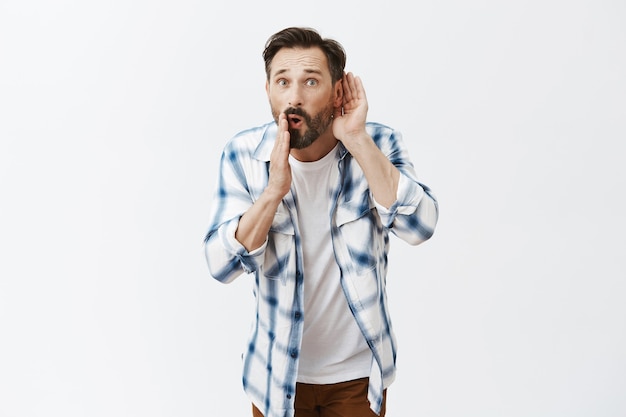 Shocked and amazed bearded mature man posing