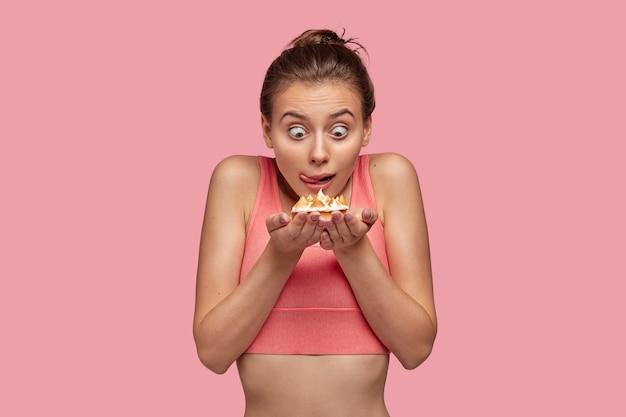 Shocked amazed woman stares at cake with bugged eyes