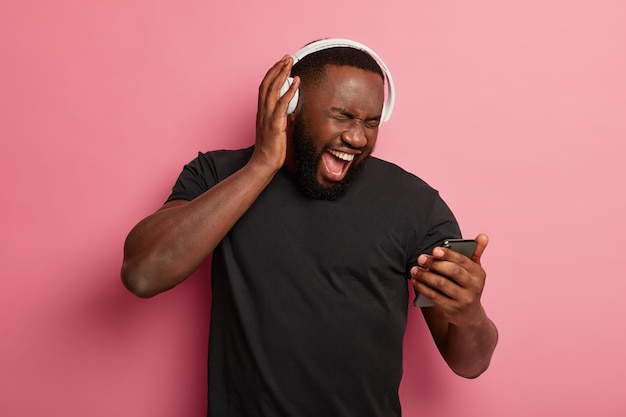 Shocked bearded man with dark skin excited from winning big discounts