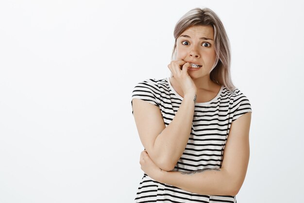 Shocked blonde girl posing in the studio