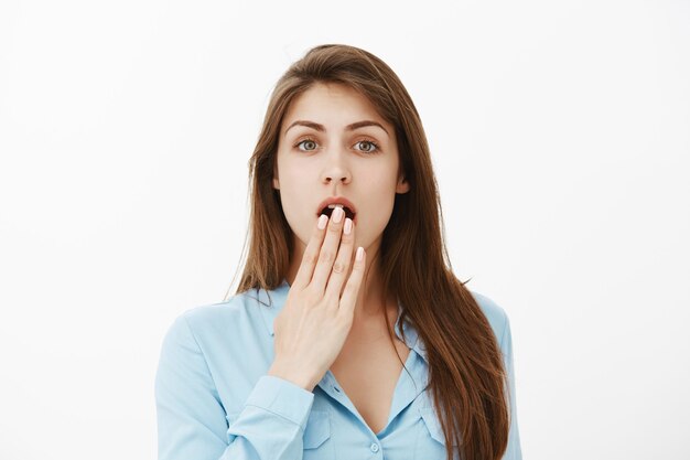 shocked brunette businesswoman posing in the studio