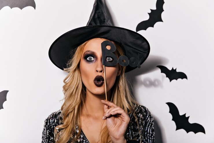 Free Photo shocked caucasian woman with gray eyes posing in halloween. indoor photo of debonair female vampire isolated on white wall.