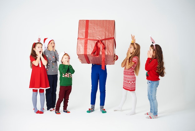 Shocked children looking at huge gift