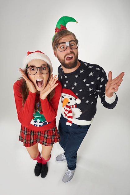 Shocked couple on grey wall