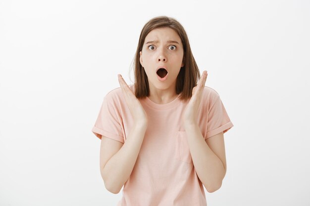 Shocked and disappointed woman gasping, looking upset as failed exams, losing competition