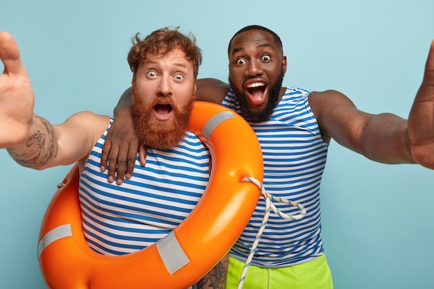 Shocked friends posing with beach items