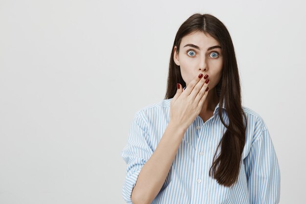 Shocked gasping woman cover mouth with hand