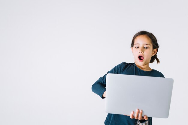 Shocked girl browsing laptop
