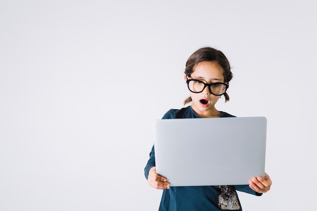 Shocked girl looking at laptop