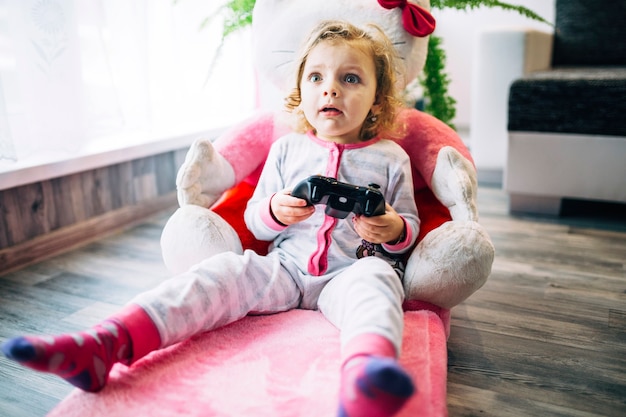 Shocked girl playing video game