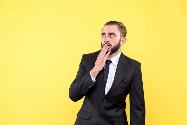 Shocked guy closing his mouth with his fingers