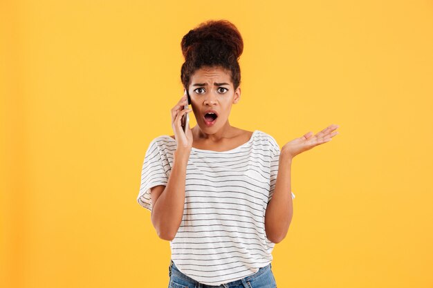 Shocked lady talking on phone