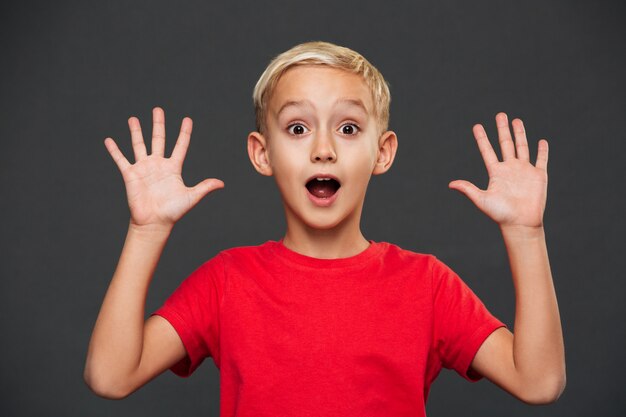 shocked little boy child standing isolated