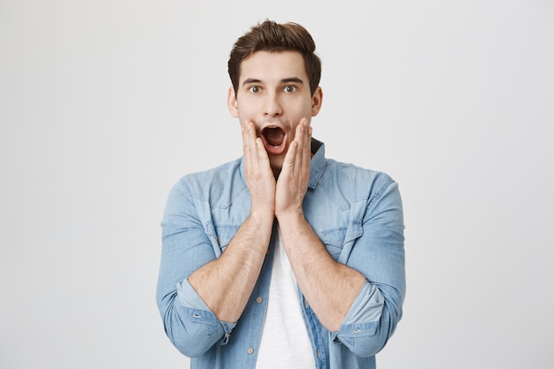 Shocked man drop jaw from amazing news