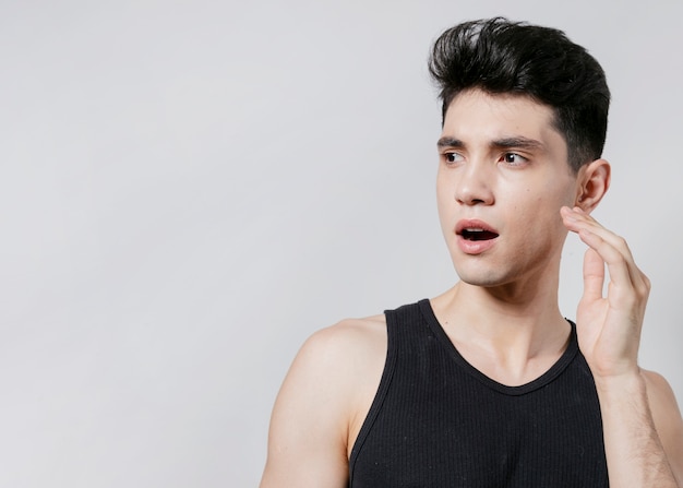 Shocked man posing in tank top