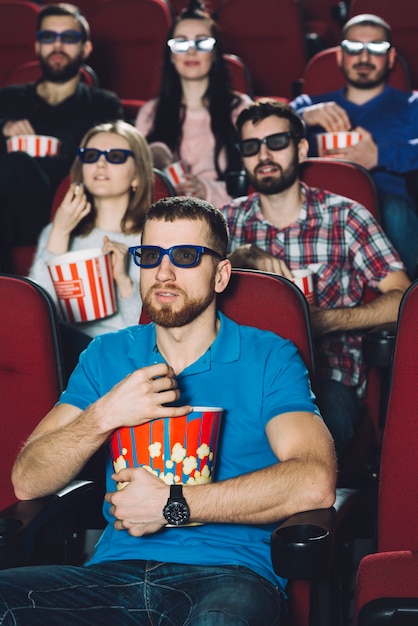 Shocked people watching film in cinema