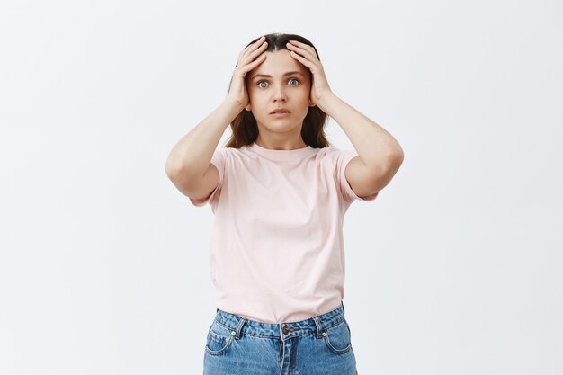 Shocked and startled young brunette posing