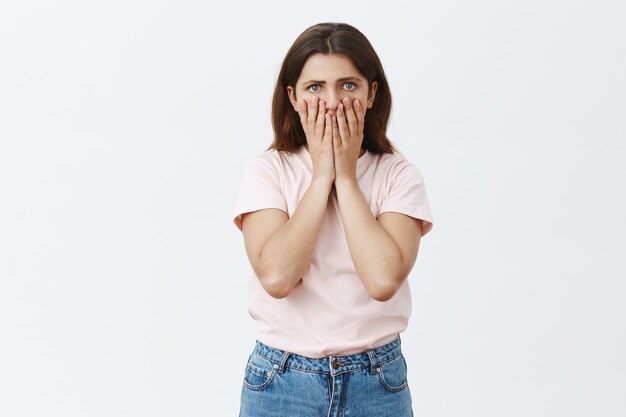 Shocked and startled young brunette posing