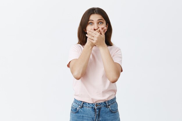 Shocked and startled young brunette posing