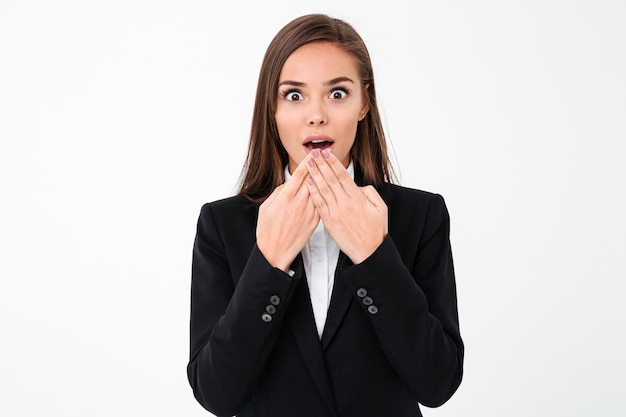 Shocked surprised business woman standing isolated