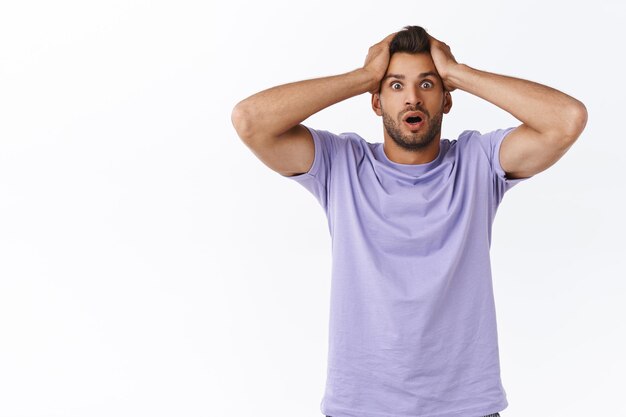 Shocked troubled and panicking young alarmed sexy guy with beard, forgot take-out chicken from fridge before wife came, grab head puzzled, gasping staring distressed and alarmed