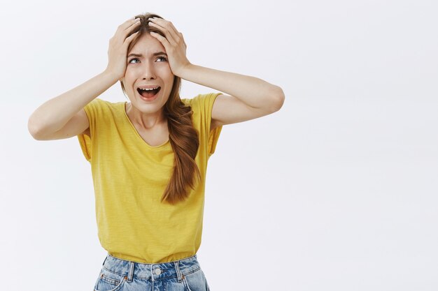 Shocked and troubled young woman looking frustrated and concerned, panicking