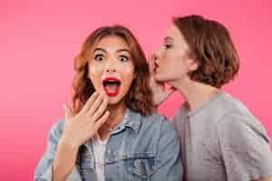 Free photo shocked two women friends gossiping.