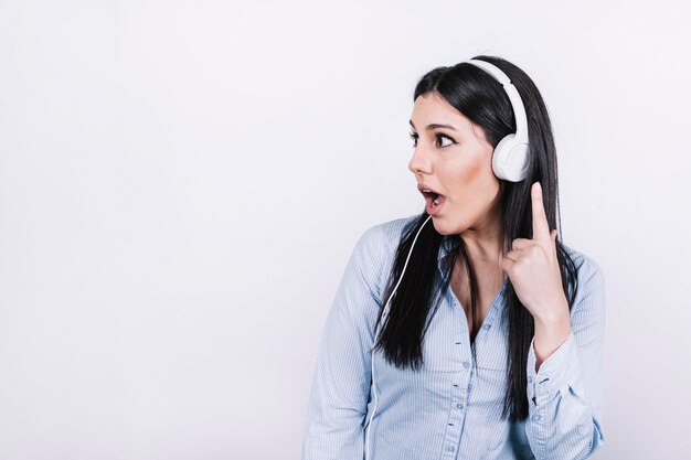 Shocked woman listening to music