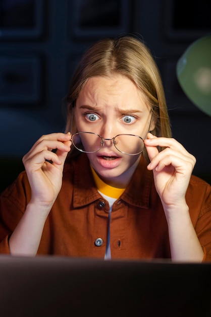 Shocked woman looking at her laptop