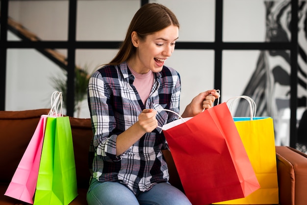 Free photo shocked woman looking inside bags