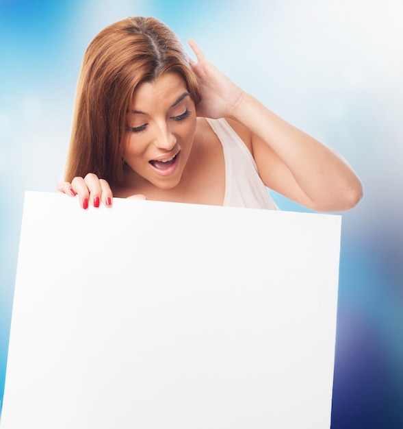 Shocked woman looking at white board.