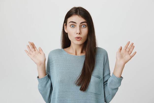 Shocked woman raise hands up in surprise