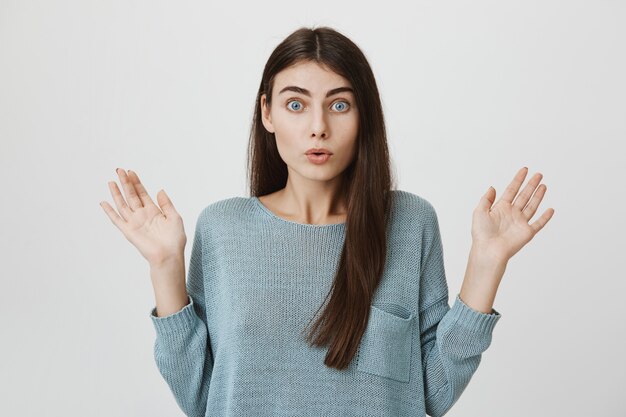 Shocked woman raise hands up in surprise