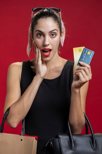 Shocked woman showing her credit cards