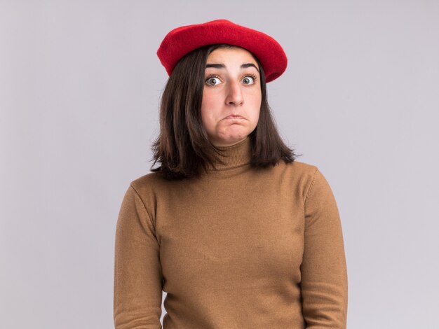 Shocked young pretty caucasian girl with beret hat  isolated on white wall with copy space