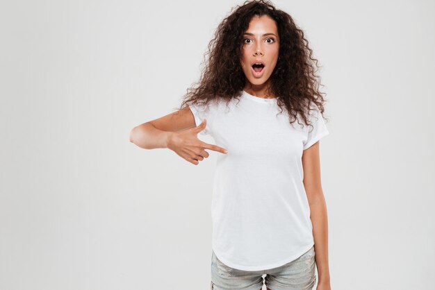 Shocked young woman with curly hair
