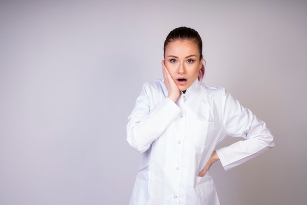 Shocking girl in white doctor uniform