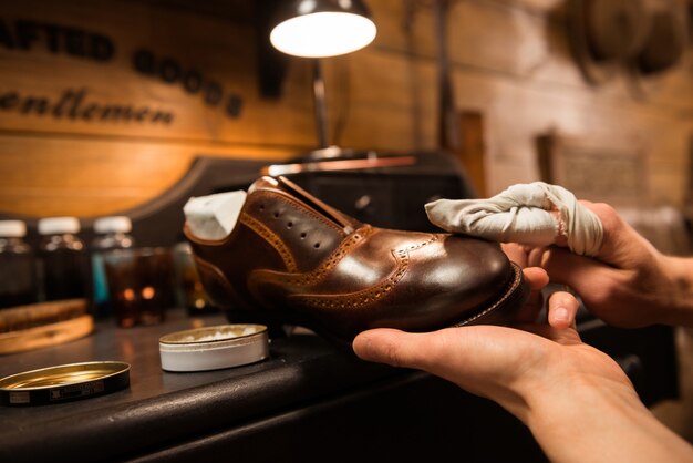 Shoemaker in workshop making shoes