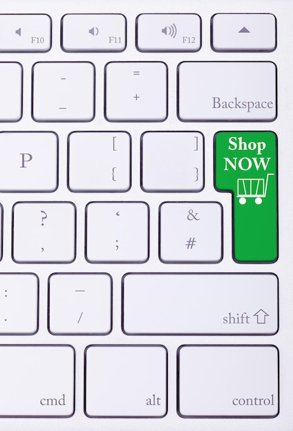 Free photo shop now green key on aluminium keyboard. sale and online shoping. consumerism