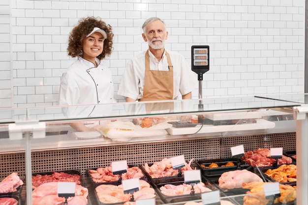 Shop workers posing behind counter.