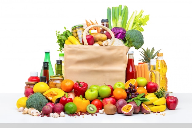 Shopping bag full of fresh fruits and vegetables with assorted ingredients Premium Photo