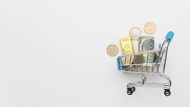 Shopping cart filled with money copy space