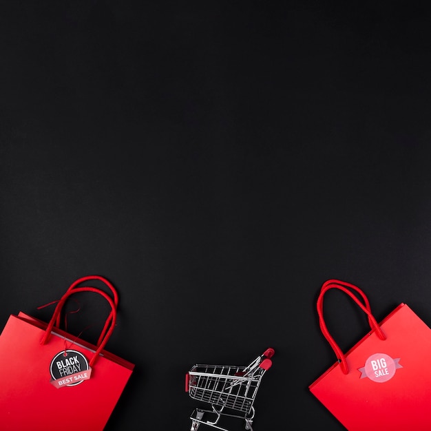 Shopping cart between red bags