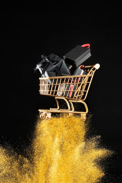 Free photo shopping cart with gifts arrangement in golden glitter