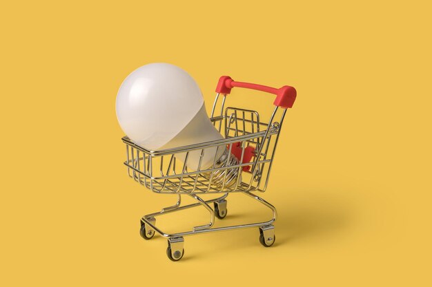 Shopping cart with a light bulb. mini cart. online purchase of light bulbs.