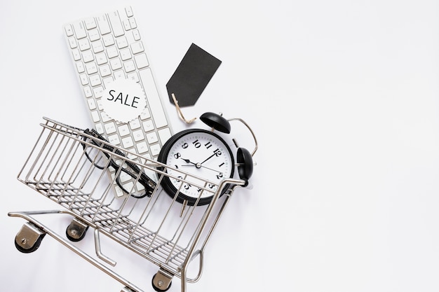 Shopping cart with objects and sale sticker