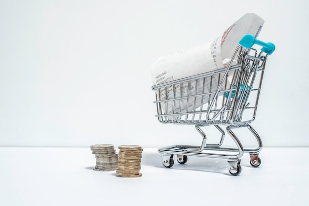 Shopping cart with purchased receipt and euro coins