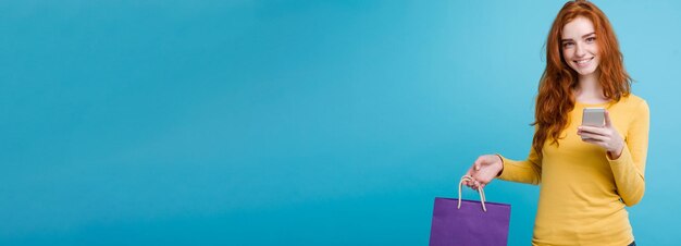 Shopping concept close up portrait young beautiful attractive redhair girl smiling looking at camera