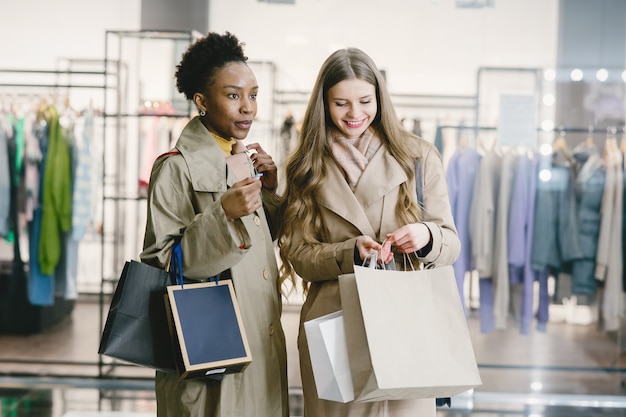 Shopping day. International girlfriends. Women in a mall.