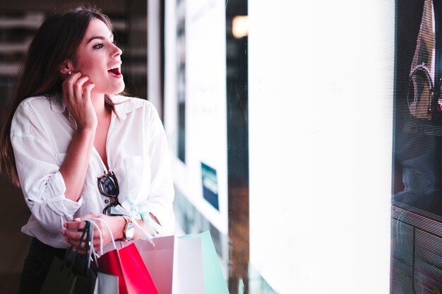 Shopping girl looking at store window